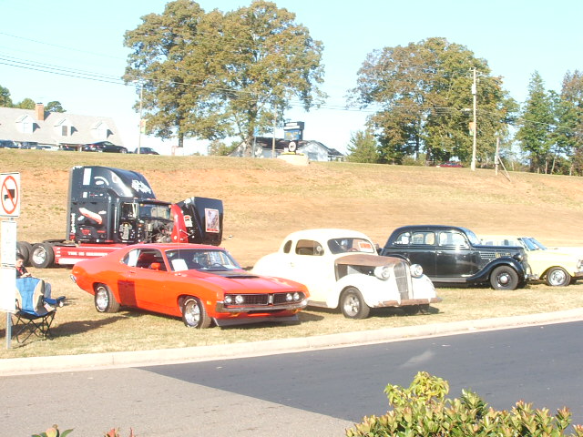 Orange muscle car with hood scoop and side vents