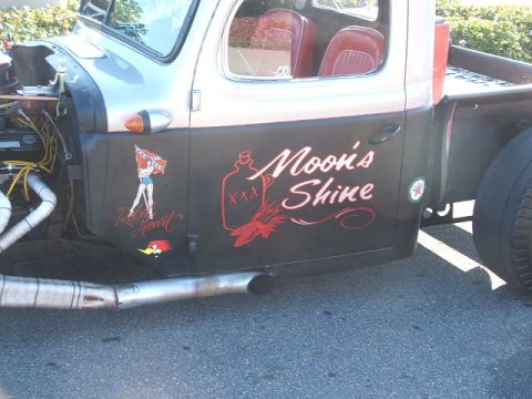 1971 Ford Ranchero - This customized truck features unique artwork on its side, including text and graphics.