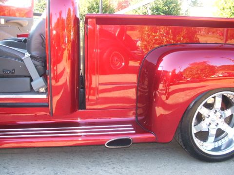 1971 Ford Ranchero - A red pickup truck is shown from the side, custom wheels and chrome trim.