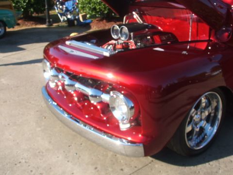 1971 Ford Ranchero - Customized red truck front end with a prominent chrome grille and exposed engine components.