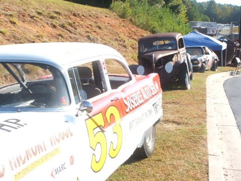 1971 Ford Ranchero - A white race car with the number 53 prominently displayed on its side is parked alongside other vehicles.