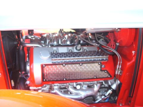 1971 Ford Ranchero - Close-up view of a custom engine bay polished components and vibrant red accents.