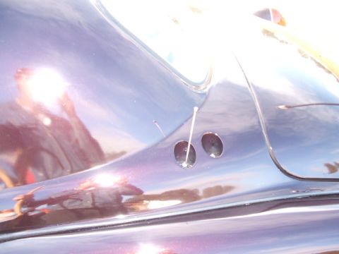 1971 Ford Ranchero - Detail shot of a car's body panel, two circular openings.