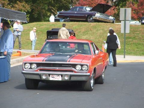 1971 Ford Ranchero - Orange 1970 Plymouth Road Runner parked outdoors, with another classic car in the background.
