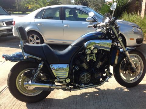 1996 Yamaha V-Max - A Yamaha V-Max motorcycle is parked in front of a silver sedan on a paved surface.