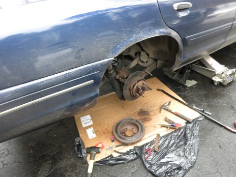 2001 Ford Crown Victoria - Working on the rear brakes of a 2001 Ford Crown Victoria, car is jacked up.