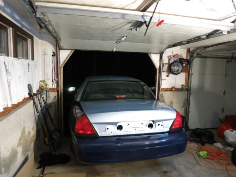 2001 Ford Crown Victoria - A Ford Crown Victoria is parked in a garage, with its rear bumper removed and ready for work.