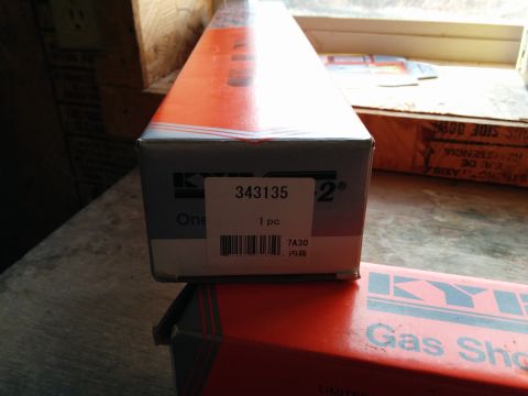 2007 Ford Crown Victoria - Cardboard packaging for automotive parts, specifically KYB gas shocks, is visible.