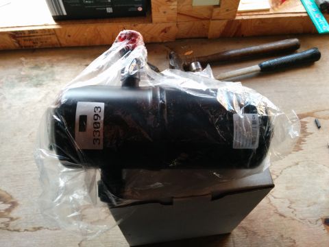 2007 Ford Crown Victoria - A black automotive part, possibly a filter or canister, is shown in plastic packaging.