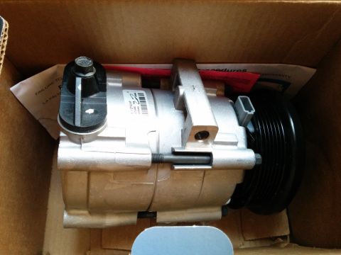 2007 Ford Crown Victoria - An air conditioning compressor is shown inside its packaging, with a label indicating part number 01147-C.