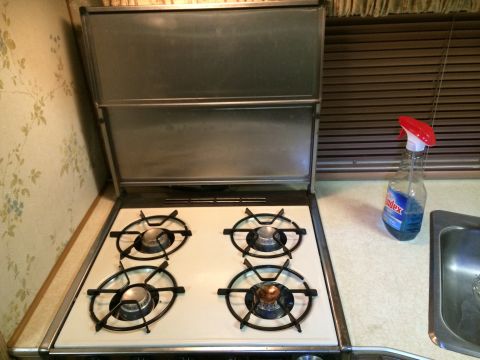 1997 Dodge 3500 - Interior shot of an RV kitchen area showing a stove, sink, and cleaning spray.