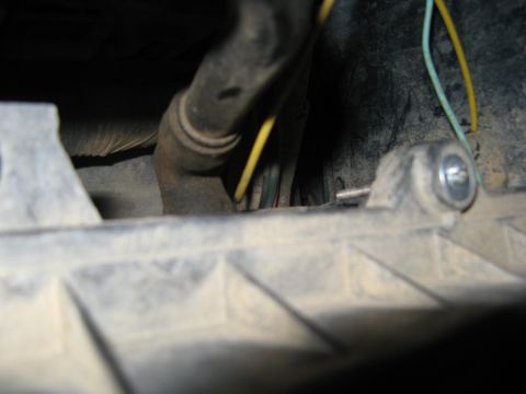 1995 Ford Bronco - A close-up view of wiring and hoses within the engine compartment.
