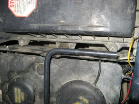 1995 Ford Bronco - Close-up view of engine components, including the air cleaner housing and radiator fan.