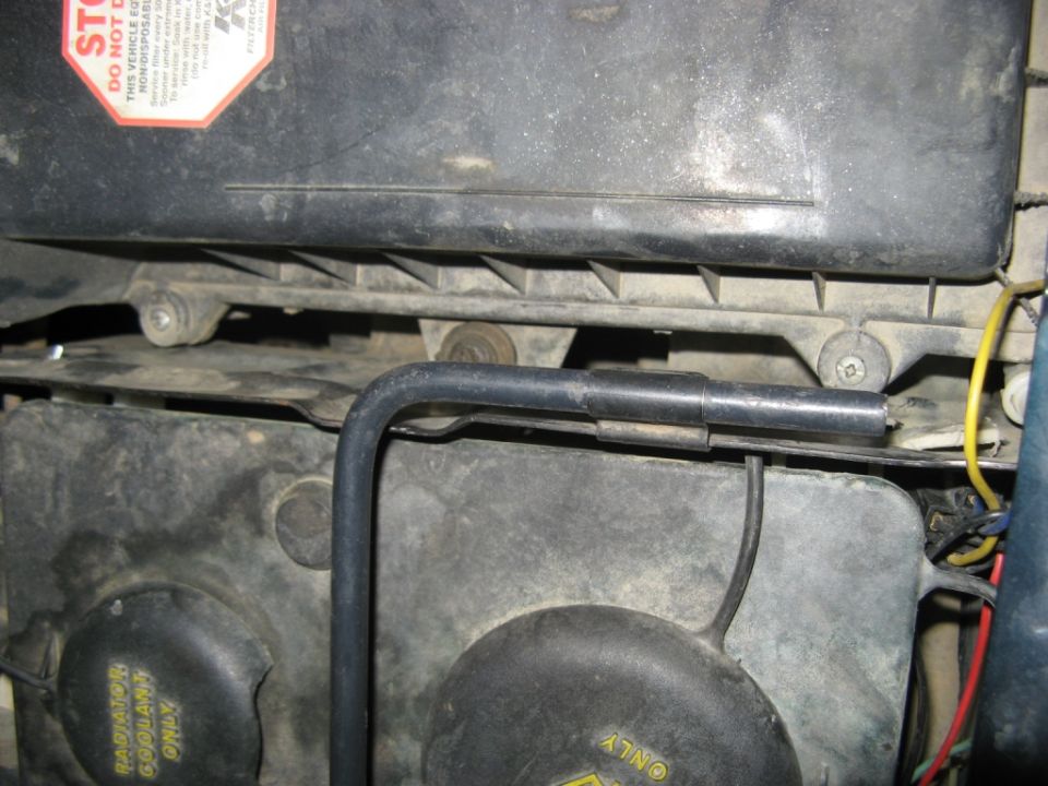Air cleaner housing and radiator fan with yellow warning labels