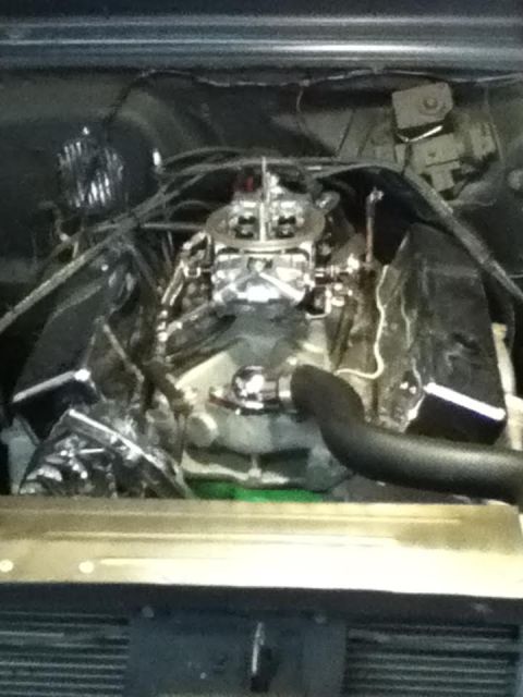 1963 Chevrolet Nova - The engine bay of a vehicle is shown with a prominent carburetor and chrome accents.