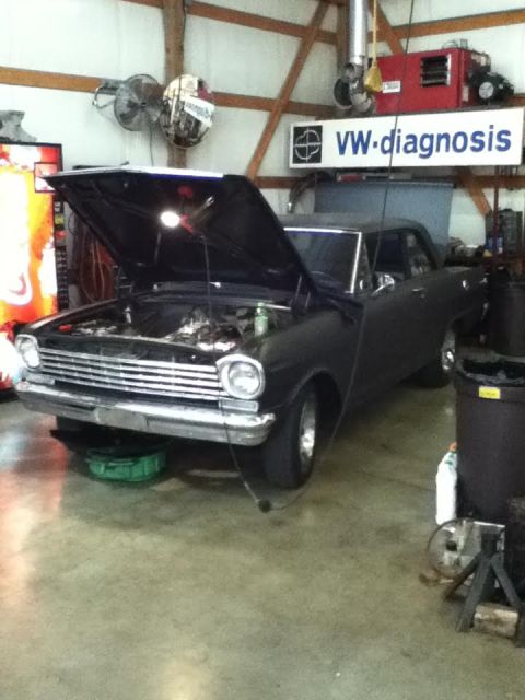 1963 Chevrolet Nova - A 1963 Chevrolet Nova is parked in a garage with its hood up, undergoing maintenance.