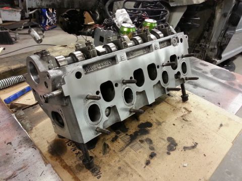 2002 Volkswagen Jetta - A disassembled engine cylinder head with "VW GERMANY" visible is shown on a workbench.