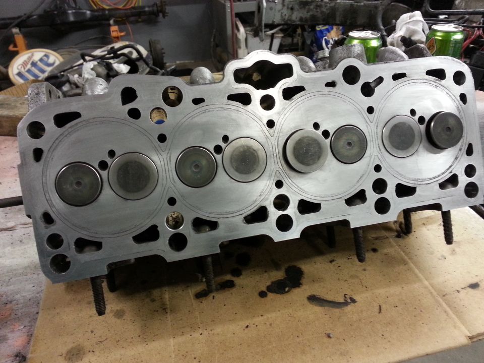 Close-up of a disassembled engine cylinder head with valves visible