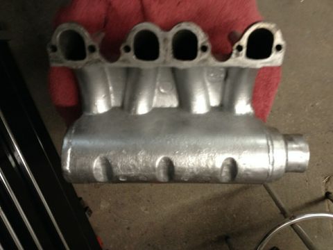 2002 Volkswagen Jetta - A silver intake manifold with four intake ports is shown, likely a replacement part.