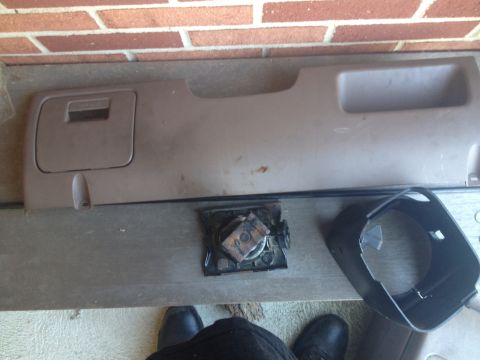 1993 Ford Bronco - Interior dashboard panel with a storage compartment and a separate speaker grille, likely from an older vehicle.