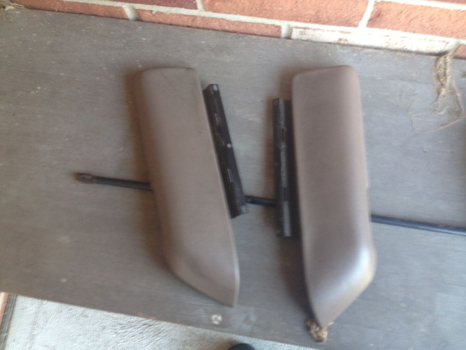 Two tan interior door panels with black metal mounting brackets