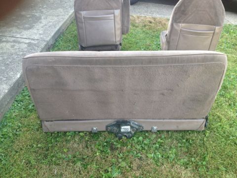 1993 Ford Bronco - Interior car seats are shown removed from the vehicle and placed on the grass.