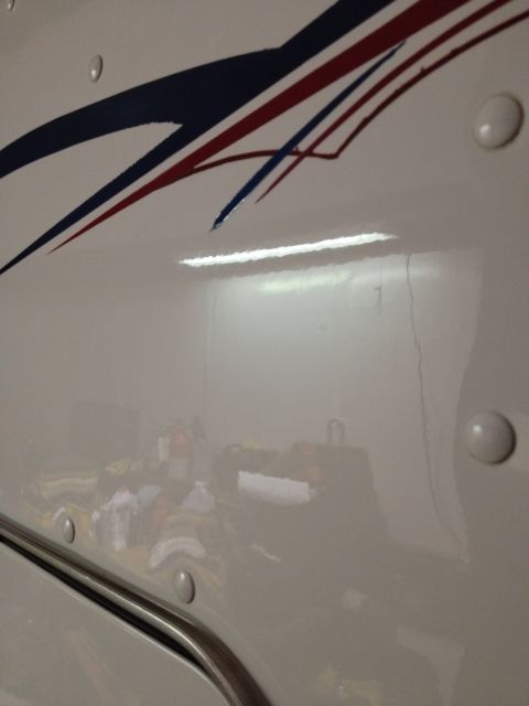 2003 Peterbilt 379 - Side view of a white truck showing graphics and rivets.