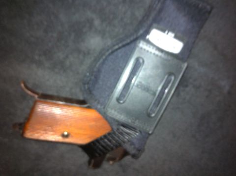 1984 BMW 3 Series - A gun holster with a wooden grip is shown in detail.