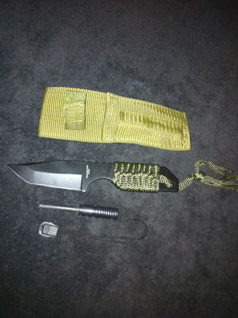 1984 BMW 3 Series - A survival knife with a paracord-wrapped handle and a sheath is shown with a fire starter tool.