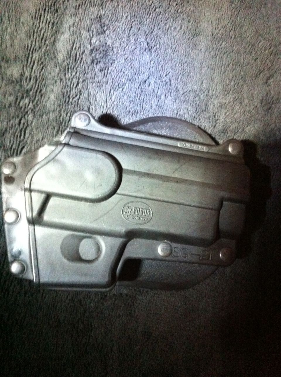 Metal part with 'POBUS' logo and 'SG-21' marking