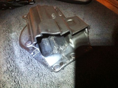 1984 BMW 3 Series - A metal bracket with a rubber insert is shown on a gray textured surface.