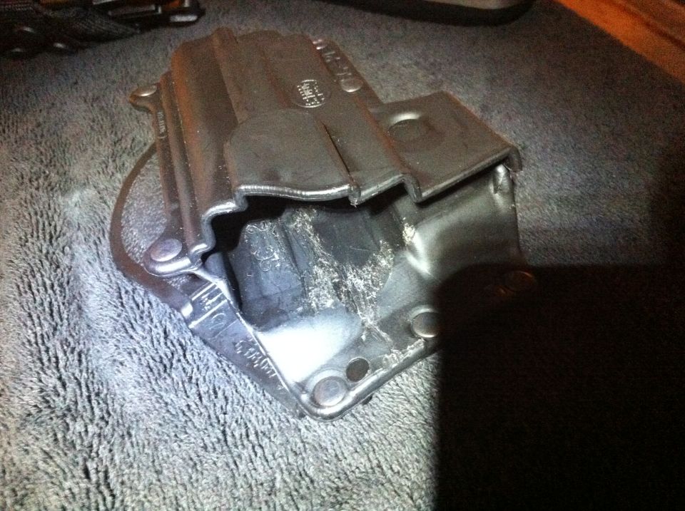 Metal bracket with rubber insert on gray textured surface