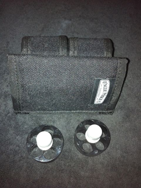 1984 BMW 3 Series - A black pouch and two speed loaders are displayed against a dark background. The pouch has a label that reads "Uncle Mike's - Since 1947."