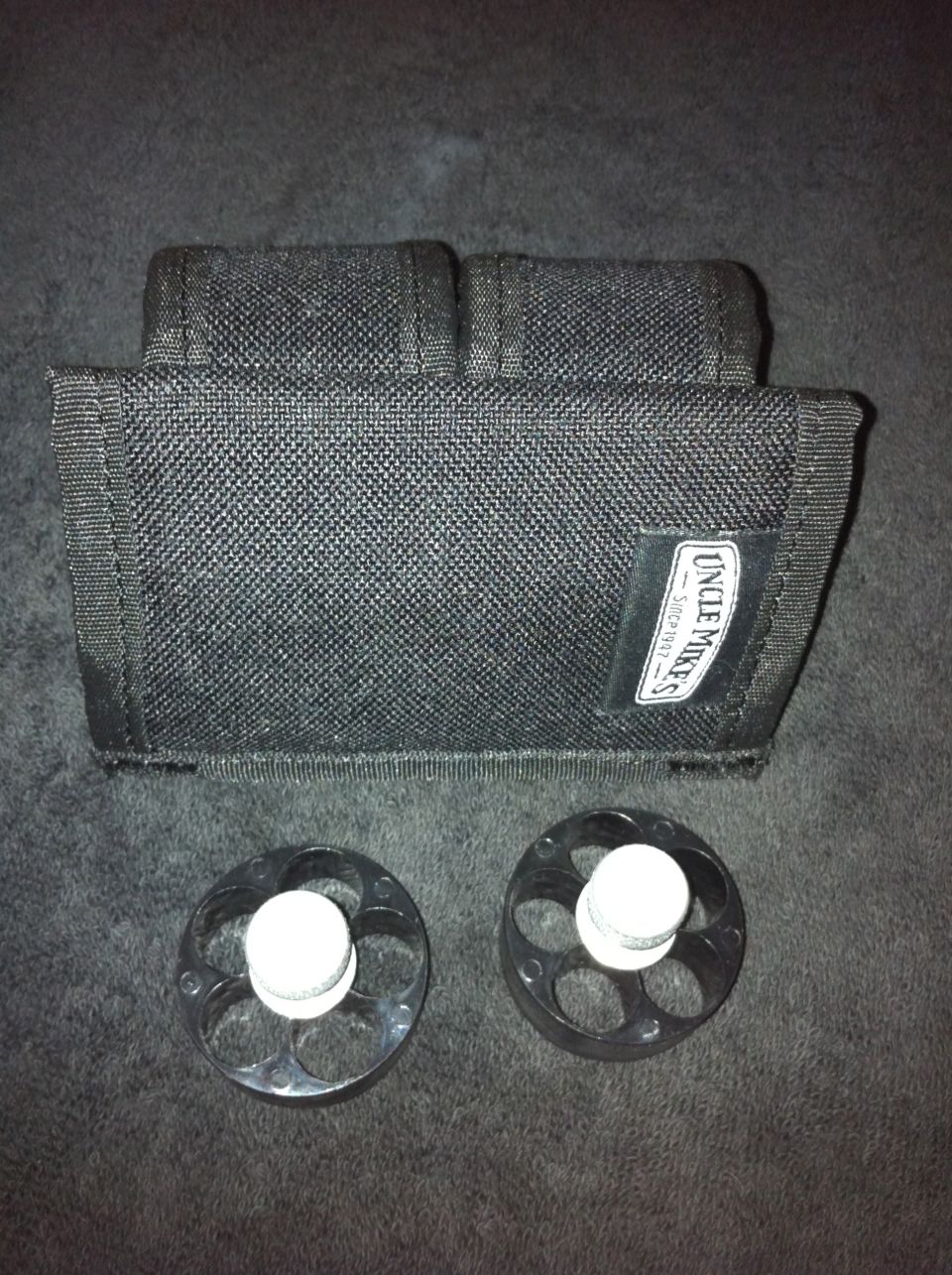 Black pouch and two speed loaders with "Uncle Mike's" label