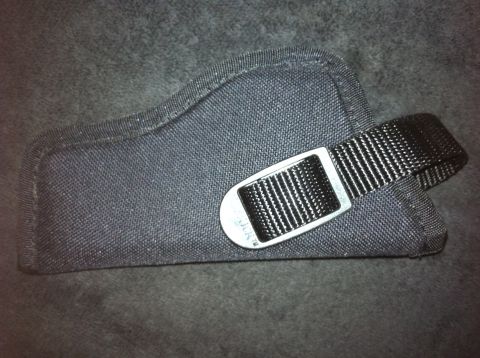 1984 BMW 3 Series - A black fabric gun holster with a metal buckle and nylon strap is shown against a textured gray background.