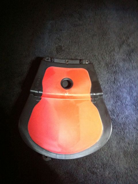 1984 BMW 3 Series - This is a car part, possibly a cover or trim piece, with a gradient of orange and red colors.