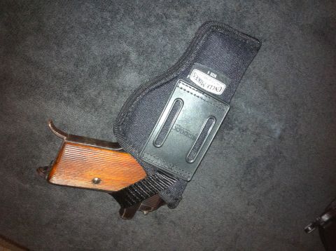 1984 BMW 3 Series - A handgun with a wooden grip is shown inside a black holster with "Uncle Mike's" branding visible.