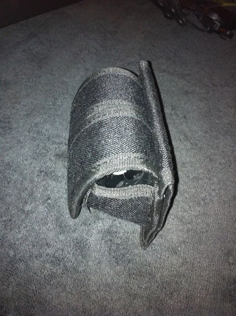 1984 BMW 3 Series - A black fabric pouch containing a white object is shown on a gray surface.