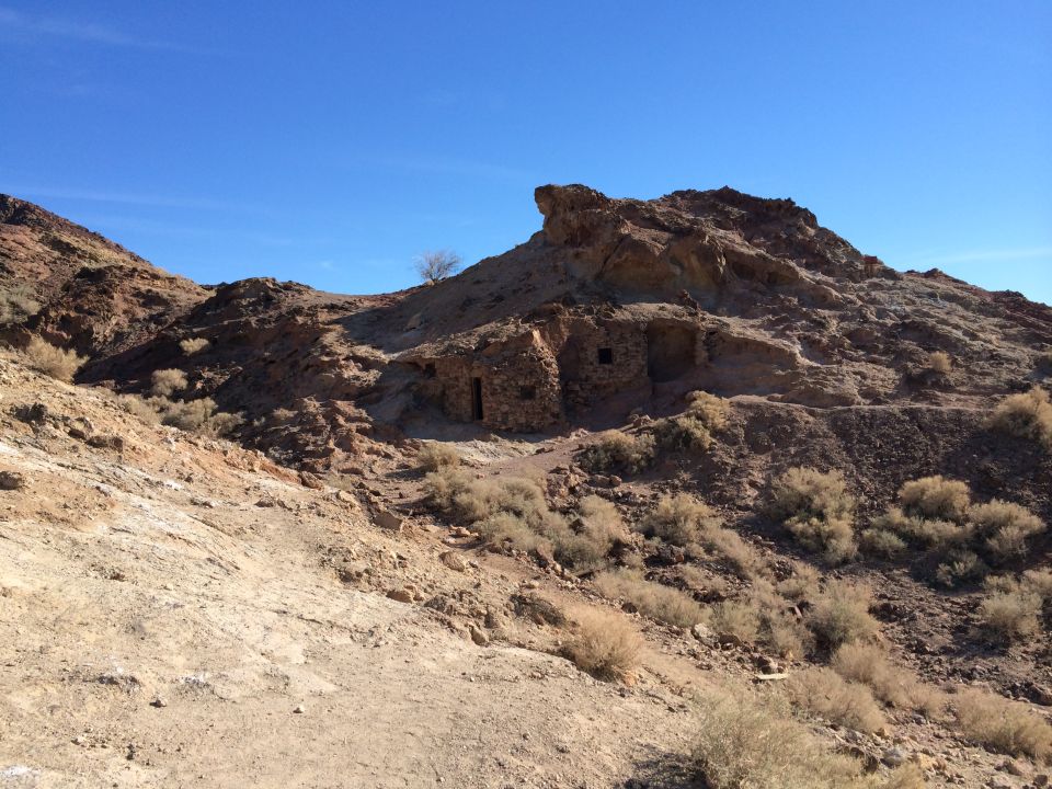 Stone structures built into a hillside under a clear blue sky