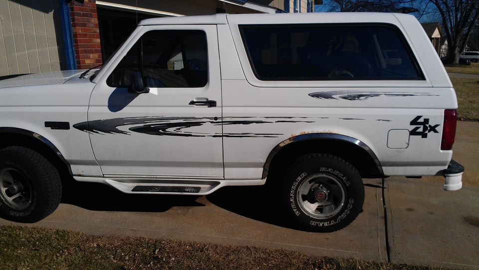 White Ford Bronco with 4x4 decal on rear quarter panel and side graphics