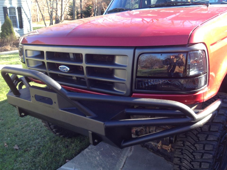 1996 Ford F-150 front end with aftermarket bumper and dark headlights
