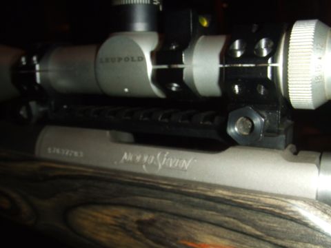 1996 Ford Bronco - Close-up of a rifle scope and receiver, showing the wooden stock and engraved text.