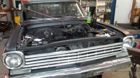 1963 Chevrolet Nova - Front view of a 1963 Chevrolet Nova with its hood open, revealing the engine bay.