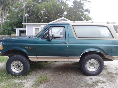 1996 Ford Bronco - This lifted Ford Bronco is shown from the side, a two-tone paint scheme and off-road tires.