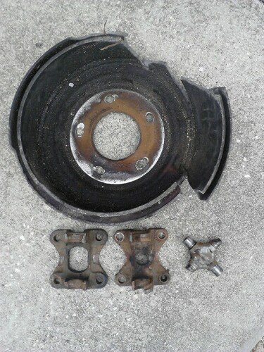 1996 Ford Bronco - Brake drum after wheel came off, 2 of the flanges that broke on the driveshaft pulling people out, and a u-joint that melted and broke. dam…