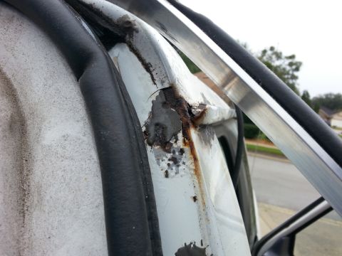 1992 Ford Bronco - a shot from the back of the passenger side drip rail before I started cleaning it up.. the grey stuff is JB weld that I had used to cover u…