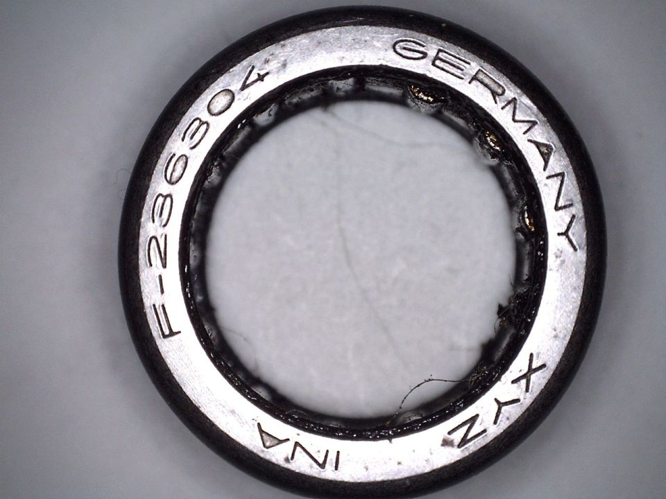 Close-up of a bearing with 'F-26304 GERMANY INA XYZ' stamped on it
