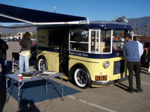 1990 Ford Bronco - A vintage-style custom truck, possibly a food truck, is parked outdoors with an awning extended.