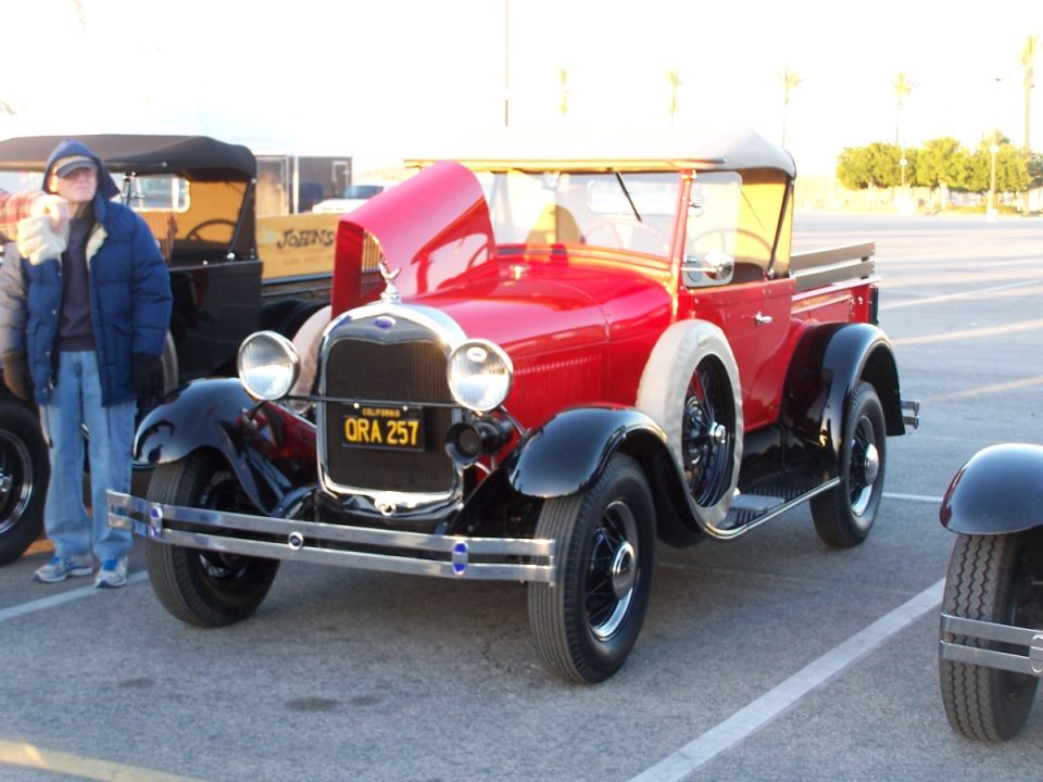 Red pickup truck with hood up, parked next to another vehicle