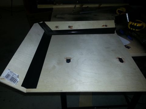 1994 Ford Bronco - A wooden panel, possibly a seat base, is shown with black tape and pre-drilled holes.